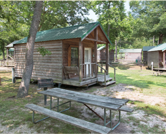 Our rustic cabins come with a picnic table and a charcoal grill.