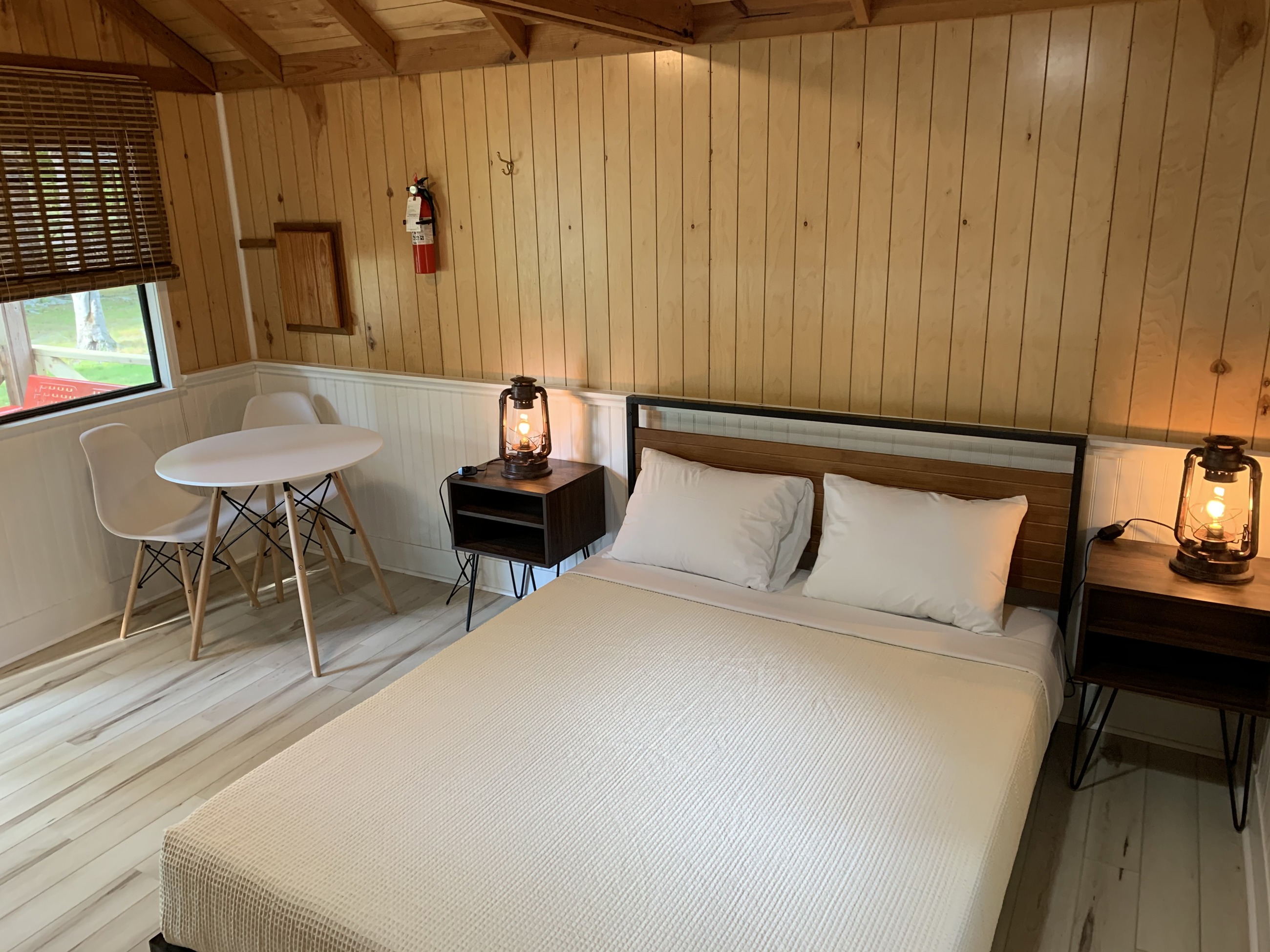 Queen size bed with linens provided and dining set for two.