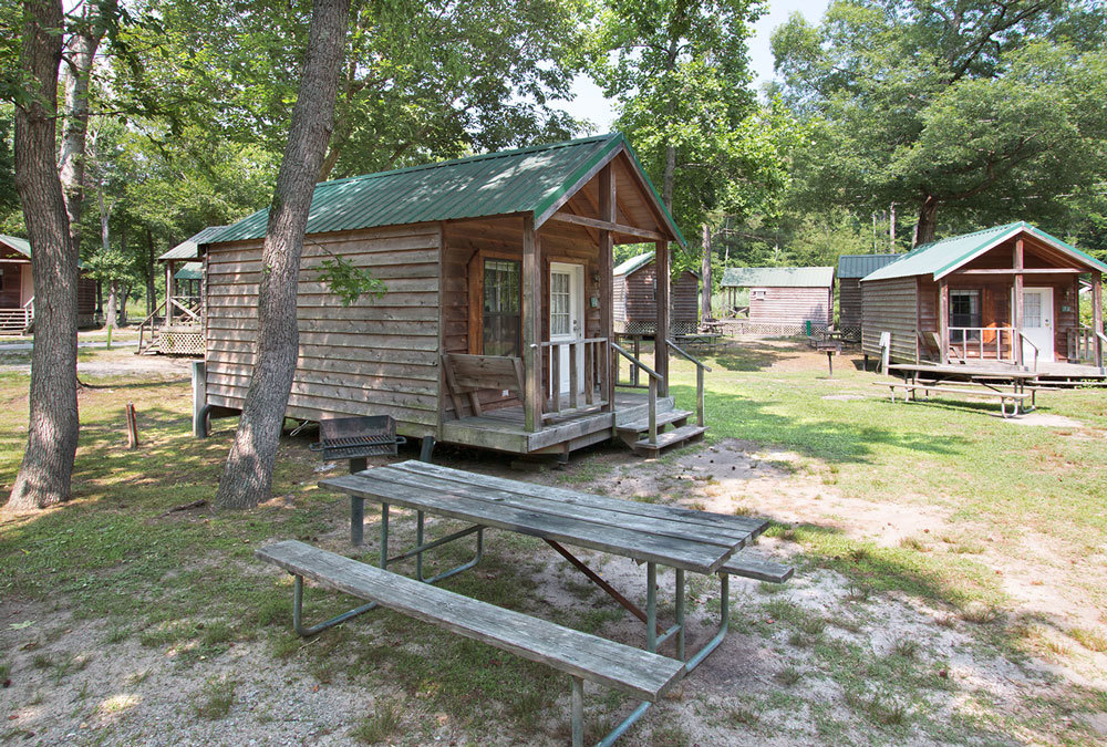 Our rustic cabins come with a picnic table and a charcoal grill.